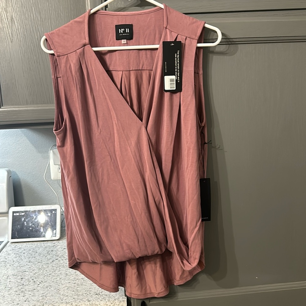 Mauve in color, sort of cropped/ cinched in front and longer in the back.